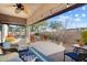 Covered patio with ceiling fan, string lights, and furniture overlooking pool at 4317 E Williams Dr, Phoenix, AZ 85050