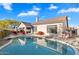 Backyard pool with lounge chairs and lush landscaping on sunny day at 4317 E Williams Dr, Phoenix, AZ 85050