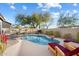 Backyard pool with lounge chairs and lush landscaping on sunny day at 4317 E Williams Dr, Phoenix, AZ 85050