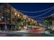 Vibrant night scene on the street with hanging lights and views of storefronts and surrounding architecture at 4317 E Williams Dr, Phoenix, AZ 85050