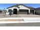 Charming single-story home with a brown two-car garage and low maintenance landscaping at 43527 N Wollemi St, Queen Creek, AZ 85140
