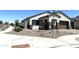 Beautiful single-story home with a three car garage, manicured yard, and street signage at 43527 N Wollemi St, Queen Creek, AZ 85140