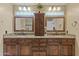 Elegant bathroom with dual sinks, granite countertops, and a central cabinet for storage at 4534 E Oberlin Way, Cave Creek, AZ 85331