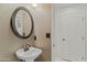 Well-lit powder room featuring a pedestal sink and decorative mirror at 4534 E Oberlin Way, Cave Creek, AZ 85331