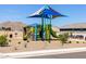 Community playground featuring slides, climbing structures, shade cover, and seating, set against a mountain backdrop at 4812 W Hunter Trl, San Tan Valley, AZ 85144