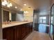 Bright bathroom featuring dual sinks, granite countertops, and large mirror at 5124 N 31St Pl # 542, Phoenix, AZ 85016