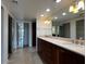 Bright bathroom featuring dual sinks, granite countertops, and large mirror at 5124 N 31St Pl # 542, Phoenix, AZ 85016