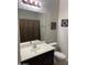 Half bathroom with a single vanity, large mirror and shower with curtain at 5350 E Deer Valley Dr # 4430, Phoenix, AZ 85054