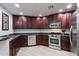 Modern kitchen featuring stainless steel appliances, dark wood cabinets, and granite countertops at 5350 E Deer Valley Dr # 4430, Phoenix, AZ 85054