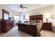 Elegant primary bedroom featuring a ceiling fan and dark wood furnishings at 5350 E Deer Valley Dr # 4430, Phoenix, AZ 85054