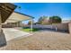 Backyard features a gravel area, covered patio, and artificial turf at 5513 W Tierra Buena Ln, Glendale, AZ 85306