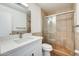 Modern bathroom with a glass shower and a white quartz vanity at 5513 W Tierra Buena Ln, Glendale, AZ 85306