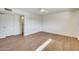 Bedroom with wood-look floors, a ceiling fan, an air vent and a glimpse of a bathroom and closet at 5513 W Tierra Buena Ln, Glendale, AZ 85306