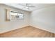 Bedroom featuring wood-look floors, neutral walls, ceiling fan, and a window at 5513 W Tierra Buena Ln, Glendale, AZ 85306