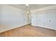 Bedroom with wood floors, closet with bifold doors, and an open doorway at 5513 W Tierra Buena Ln, Glendale, AZ 85306