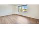 Sunny bedroom with a large window and laminate wood flooring at 5513 W Tierra Buena Ln, Glendale, AZ 85306