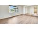 Bright bedroom with laminate wood flooring and a large window at 5513 W Tierra Buena Ln, Glendale, AZ 85306