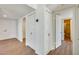 Hallway featuring wood-look flooring and white paneled doors at 5513 W Tierra Buena Ln, Glendale, AZ 85306