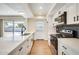 Modern kitchen features stainless appliances, white cabinetry, stone countertops, and wood-look flooring at 5513 W Tierra Buena Ln, Glendale, AZ 85306