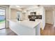 Updated kitchen featuring stone countertops, white cabinetry, stainless steel appliances, and modern lighting at 5513 W Tierra Buena Ln, Glendale, AZ 85306