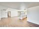 Open-concept living space with wood-look flooring, and a modern kitchen at 5513 W Tierra Buena Ln, Glendale, AZ 85306