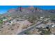 Aerial view of property showcasing house, desert landscaping, and nearby mountains at 5962 E Siesta St, Apache Junction, AZ 85119