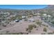 Aerial view of desert property with home and other buildings at 5962 E Siesta St, Apache Junction, AZ 85119