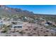 Aerial view of a desert property featuring mature landscaping, a barn, and mountain views at 5962 E Siesta St, Apache Junction, AZ 85119