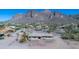 Aerial view of desert home featuring mature trees, landscaping, and mountain views at 5962 E Siesta St, Apache Junction, AZ 85119