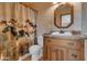 The bathroom features a vanity with granite countertops and a matching octagonal mirror at 5962 E Siesta St, Apache Junction, AZ 85119