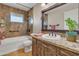 Rustic bathroom features granite counters, tub with brown marbled shower, and decorative accents at 5962 E Siesta St, Apache Junction, AZ 85119