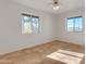 Bright, empty bedroom with tiled floors, two windows and scenic desert views at 5962 E Siesta St, Apache Junction, AZ 85119