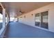 The covered patio features grey floors, ceiling fans, block supports and mountain views at 5962 E Siesta St, Apache Junction, AZ 85119