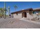 Close up of single story home with desert landscaping, cactus, arched front door entrance at 5962 E Siesta St, Apache Junction, AZ 85119