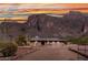 Single story home featuring desert landscaping, mature cacti, mountain views and a gated entrance at 5962 E Siesta St, Apache Junction, AZ 85119