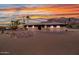 Single level home with desert landscaping set against mountain backdrop at sunset at 5962 E Siesta St, Apache Junction, AZ 85119