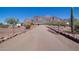 View of the front of the property, gravel driveway and mountain views at 5962 E Siesta St, Apache Junction, AZ 85119