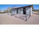 Exterior view of the horse stall with metal fencing, desert landscaping, and open stall entrances at 5962 E Siesta St, Apache Junction, AZ 85119