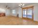 Bright living room with ceiling fan, tile floors, slider to enclosed back porch and large window at 5962 E Siesta St, Apache Junction, AZ 85119