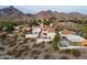 Expansive aerial shot of a residential neighborhood nestled against mountains, featuring homes and desert landscape at 6188 N 29Th Pl, Phoenix, AZ 85016