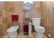 Clean bathroom with a bidet, toilet, storage shelves, and a towel rack for convenience at 6188 N 29Th Pl, Phoenix, AZ 85016