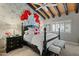 Stylish bedroom featuring a decorative accent wall, wood ceiling beams, and plantation shutters at 6188 N 29Th Pl, Phoenix, AZ 85016