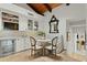 Bright breakfast nook with stone countertops, glass front cabinets, and a banquette seating area at 6188 N 29Th Pl, Phoenix, AZ 85016