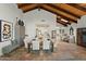 Bright dining room featuring travertine floors, wooden-beam ceilings, and an open view to the kitchen at 6188 N 29Th Pl, Phoenix, AZ 85016