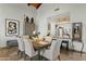 Bright dining room with an open view to the kitchen featuring travertine floors and wooden-beam ceilings at 6188 N 29Th Pl, Phoenix, AZ 85016