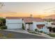 Exterior view of the house with a red tile roof, desert landscaping, and an attached garage at 6188 N 29Th Pl, Phoenix, AZ 85016