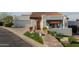 Charming front entrance with a stone walkway, red tile roof, and colorful potted plants at 6188 N 29Th Pl, Phoenix, AZ 85016