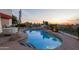 Resort-style pool featuring a waterfall, privacy landscaping, and desert views at sunset at 6188 N 29Th Pl, Phoenix, AZ 85016