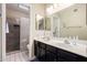 Bathroom featuring double sinks, a large mirror, and tiled floors at 6335 E Brown Rd # 1081, Mesa, AZ 85205