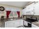 A cozy kitchen with modern appliances, white cabinets, and a sink with a window view at 6335 E Brown Rd # 1081, Mesa, AZ 85205